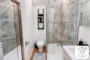 a bathroom with a shower and a toilet at The Little House in Maidstone