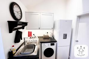 eine kleine Küche mit Spüle und Kühlschrank in der Unterkunft The Little House in Maidstone