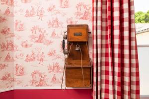 an old suitcase sitting on a shelf next to a curtain at Chateau Carbonneau in Pessac-sur-Dordogne