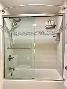 a glass shower door with a toilet in a bathroom at Bohemian Bliss 10 Min from DT SJ in San Jose