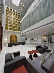 a lobby with couches and a table in a building at Pride Resort, Rajkot in Rajkot