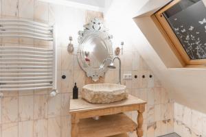 a bathroom with a sink and a mirror at Bodensee-Suite I Seenähe - Heimkino - Wintergarten in Öhningen +37 photos