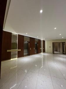 an empty lobby with a large room with glass walls at Pride Resort, Rajkot in Rajkot