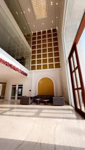 a large lobby with a large room with a table at Pride Resort, Rajkot in Rajkot
