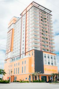 un grande edificio con arancione e bianco di La Vela Hue Hotel a Hue