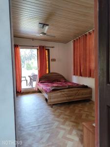 a bedroom with a bed in a room with a window at Mauli Cottage in Kashid