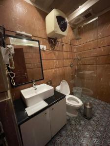 a bathroom with a sink and a toilet and a mirror at Sumitel Gangtok Resort in Gangtok +45 photos
