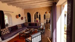 ein Wohnzimmer mit einem Sofa und einem Tisch in der Unterkunft Dar Luce in Essaouira