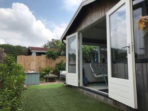 an open sliding glass door on a house with a yard at Beachhouse Rockanje in Rockanje