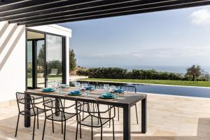 a dining room with a table and chairs on a patio at Redimeti Country House in Avola