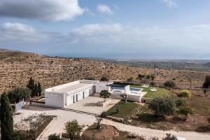 an aerial view of a white house on a hill at Redimeti Country House in Avola