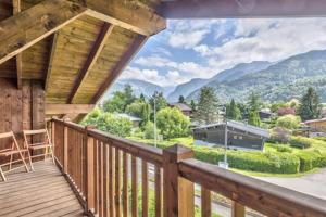 a wooden deck with a view of mountains at Le Chardon Argenté T4 Duplex 7 couchages - Parking in Samoëns