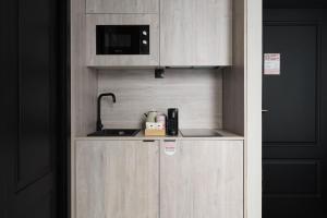 a small kitchen with a sink and a microwave at numa I Luna Apartments in Madrid