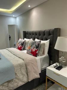 a bedroom with a large bed with two flowers on it at Le Rosette Residence in Empangeni