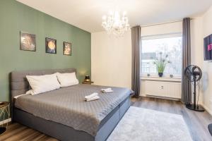 a bedroom with a large bed and a window at Luxus Penthouse, Klima, BBQ, Whirlpool in Warendorf