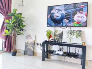 a living room with a flat screen tv on a wall at SkyHome @ D'Perdana Kota Bharu in Kota Bharu