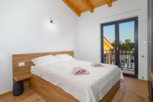 a bedroom with a bed with two towels on it at Villa Fierra by IstriaLux in Svetvinčenat +64 photos