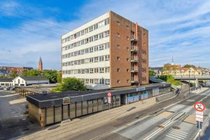 a tall building on the side of a street at Nordic style apartment in central Aalborg in Aalborg