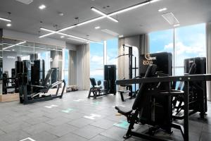 a gym with treadmills and exercise equipment in a building at PANORAMA OCEANFRONT SUITE in Nha Trang