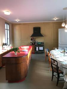 a kitchen with a long table and a kitchen with a counter at Maison familiale éco rénovée in Ault