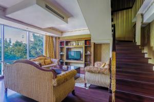 a living room with two chairs and a staircase at Darhan Boutique Hotel in Tashkent