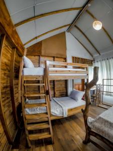 a room with two bunk beds in a house at LAMIACEAE WOOD CABIN in Ella