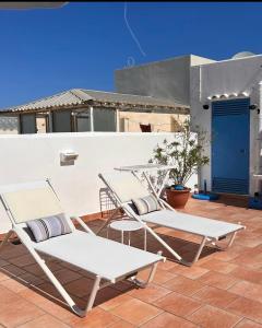 a couple of chairs sitting on a patio at Attico Vista Mare Trapani in Trapani