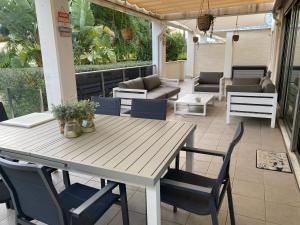 eine Terrasse mit einem Tisch, Stühlen und einem Sofa in der Unterkunft Lujoso apartamento a 150 m del mar in Denia