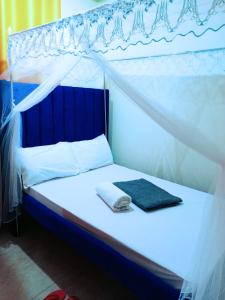 niebiesko-białe łóżko z baldachimem w obiekcie Bamburi 2 bedroom Luxury homes w mieście Bamburi