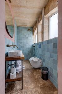 a bathroom with a sink and a tub and a toilet at Talbot House by Talbot & Bons in Luqa