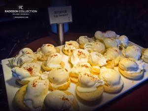 a white plate of pastries on a table at Radisson Collection Hyland Shanghai in Shanghai