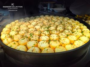 a large pot filled with lots of new potatoes at Radisson Collection Hyland Shanghai in Shanghai