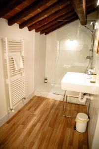 a bathroom with a white sink and a shower at Pietra di Verona Residenza in Verona