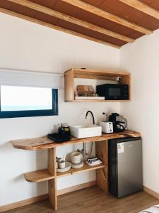 a kitchen with a wooden counter and a refrigerator at Casa Franca in José Ignacio