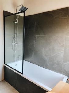 a bathroom with a shower with a white tub at Casa Franca in José Ignacio