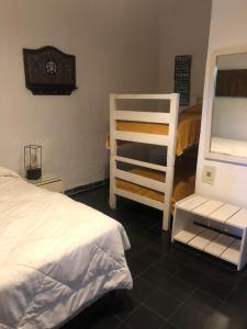 a bedroom with a bunk bed and a ladder at Amaaral in Rocha