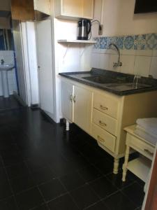 a kitchen with a sink and a counter top at Amaaral in Rocha