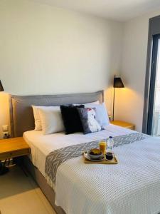 a bedroom with a bed with a tray of food on it at Luxury Maisonette with Shared Pool in Athens +20 photos