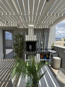 a patio with a fireplace on a balcony at Luxury Maisonette with Shared Pool in Athens