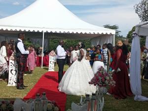 a bride and groom walking down the aisle at a wedding at INFINITE GREEN EVENTS GARDEN AND ACCOMMODATION in Dowsonville