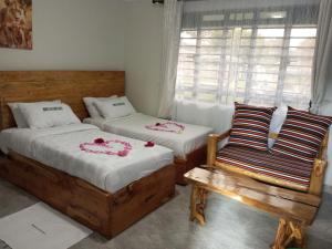 A bed or beds in a room at INFINITE GREEN EVENTS GARDEN AND ACCOMMODATION