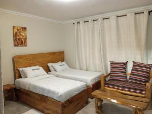 A bed or beds in a room at INFINITE GREEN EVENTS GARDEN AND ACCOMMODATION