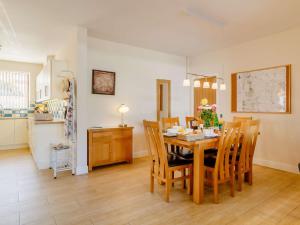 a kitchen and dining room with a table and chairs at 3 bed in Sandringham 43259 in Dersingham