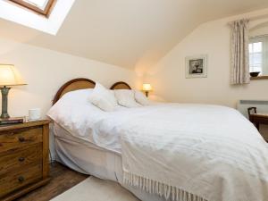 1 dormitorio con 1 cama con sábanas y almohadas blancas en 1 bed in Shipston-on-Stour CC011 en Cherington