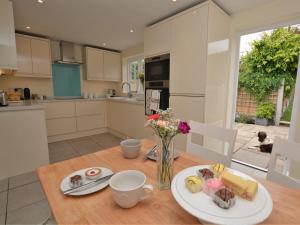 a kitchen with a table with a plate of food on it at 1 Bed in Sherborne 51018 in Bradford Abbas