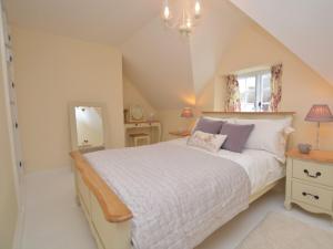 a bedroom with a large bed and a window at 1 Bed in Sherborne 51018 in Bradford Abbas