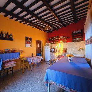 a room with two tables and a kitchen with a refrigerator at Due Passi Dal Centro in Marsala