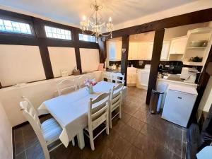 a kitchen and dining room with a white table and chairs at 12A College Hill by Sleep Shrewsbury in Shrewsbury