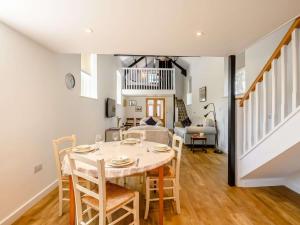 a dining room and living room with a table and chairs at 2 Bed in Fordingbridge 56823 in Woodgreen
