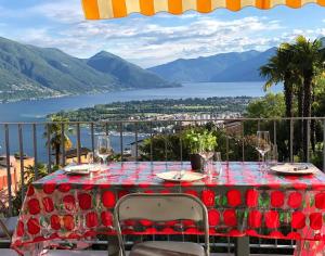 einen Tisch mit Blick auf das Wasser und die Berge in der Unterkunft Casa Collina in Locarno